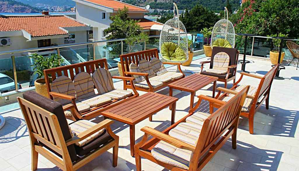Shaded terrace with wooden seating and mountain views